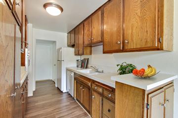 Westwood apartment for rent - A kitchen with wooden cabinets and a white refrigerator.