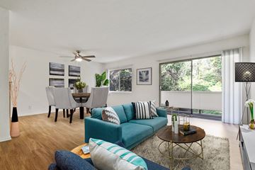 Brentwood apartment for rent - A living room with a blue couch and a coffee table.
