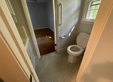 Fayetteville house for rent - a small bathroom with a toilet and a window