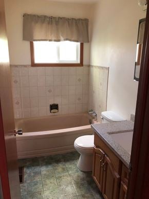 Prince Albert house for rent - A bathroom with a toilet, sink, and bathtub.