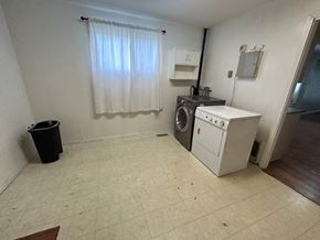Prince Albert house for rent - a laundry room with a washing machine and a washer in it