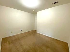 Merced house for rent - a empty living room with white walls and carpet