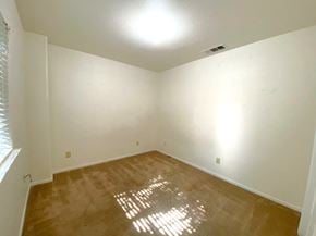 Merced house for rent - a empty room with a wooden floor and white walls