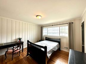Greenville house for rent - a bedroom with a bed and a desk and a window