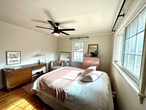 Greenville house for rent - a bedroom with a bed and a ceiling fan