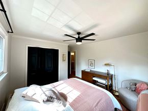 Greenville house for rent - a bedroom with a bed and a ceiling fan