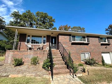 Greenville house for rent - the front of a brick house with stairs and a porch