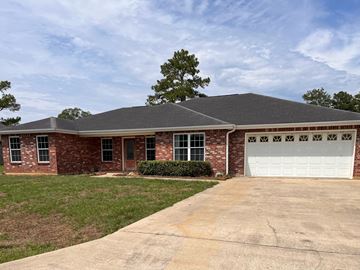 Deridder house for rent - a brick house with a white garage door