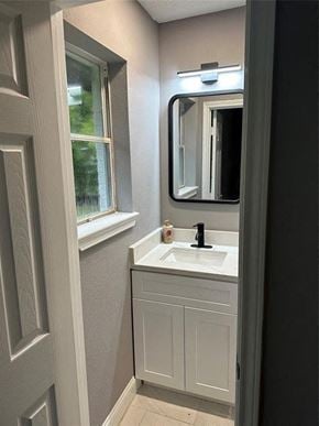 Houston house for rent - a small bathroom with a sink and a mirror