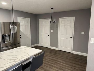 Houston house for rent - a kitchen and dining room with white doors and a table