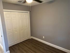 Houston house for rent - a bedroom with two closets and a wood floor