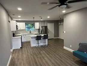 Houston house for rent - a kitchen and dining room with a wood floor