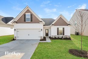 Greenville house for rent - A house with a brown roof and a white garage door.