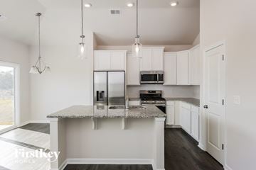 Greenville house for rent - A kitchen with a granite countertop and a microwave on top.