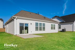 Greenville house for rent - A house with a brown roof and a white exterior is shown with the words "FirstKey Homes" on the bottom left.
