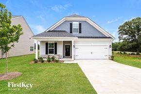 Greenville house for rent - a white and blue house with a lawn and a driveway