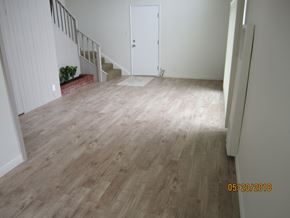 Long Beach apartment for rent - A room with a wooden floor and a white door.