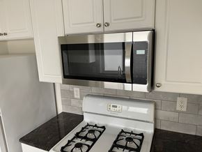 Long Beach apartment for rent - A kitchen with a stove and a microwave above it.