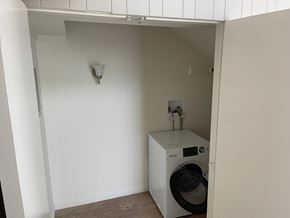 Long Beach apartment for rent - A washing machine is sitting in a small alcove.