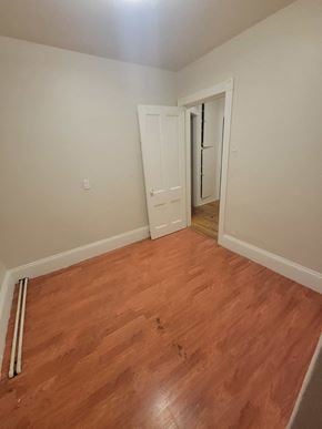 New Glasgow apartment for rent - a bedroom with wood flooring and a door to a hallway