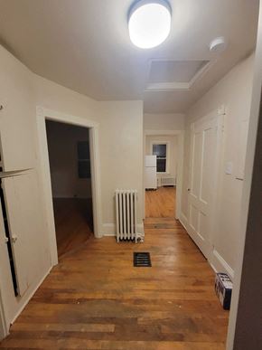 New Glasgow apartment for rent - a living room with a wood floor and a white radiator