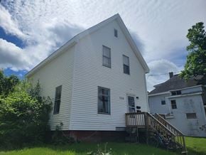 New Glasgow apartment for rent - the side of a white house with a porch and a bike parked on the deck