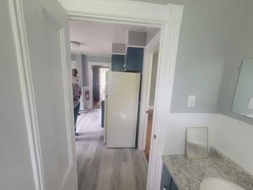 New Glasgow apartment for rent - a small kitchen with a white refrigerator and a door to a hallway