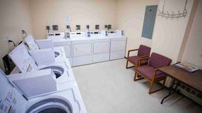 Peterborough apartment for rent - a laundry room with washing machines and a table with chairs