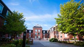 Peterborough apartment for rent - a courtyard in front of a building on a sunny day