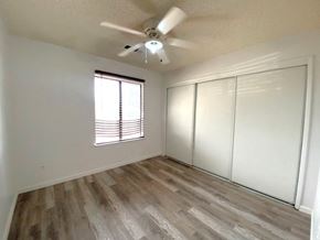 Atwater house for rent - an empty living room with white walls and a ceiling fan