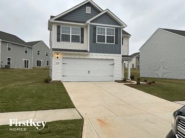 Charlotte house for rent - a gray house with a white garage door on a driveway