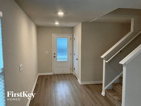 Charlotte house for rent - a hallway with a white door and stairs and a door to the beach