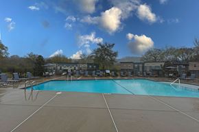 Chattanooga townhouse for rent - A large outdoor swimming pool with a blue water surface and white lines on the ground.