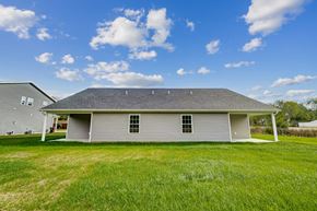 Elida apartment for rent - a white house in the middle of a grassy field