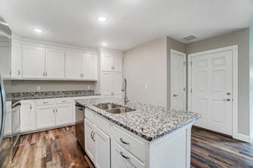 Elida apartment for rent - a kitchen with white cabinets and granite counter tops