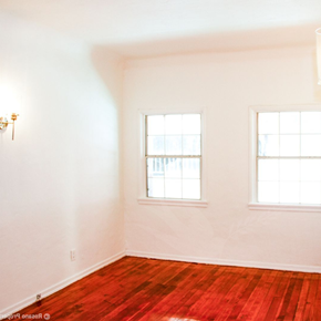Los Angeles apartment for rent - a empty room with two windows and a wooden floor