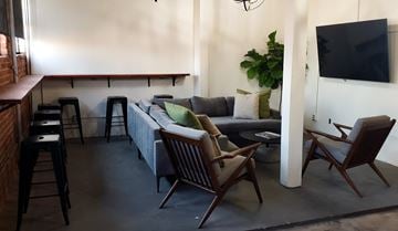 Los Angeles apartment for rent - A living room with a grey couch, two chairs and a television.