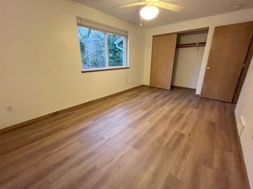 Kelso house for rent - an empty living room with wooden floors and a window