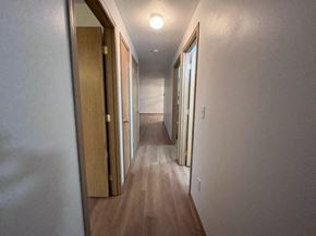 Kelso house for rent - a hallway with many doors and a light on the ceiling