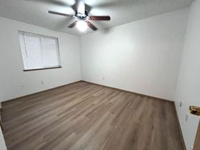Kelso house for rent - an empty room with a ceiling fan and wood floors