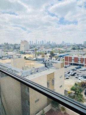 Los Angeles apartment for rent - A cityscape with buildings and cars is visible from a high vantage point.