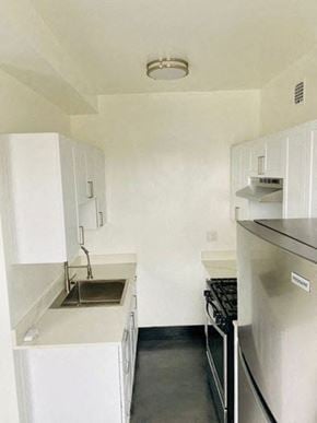 Los Angeles apartment for rent - A small kitchen with a sink, stove, and refrigerator.
