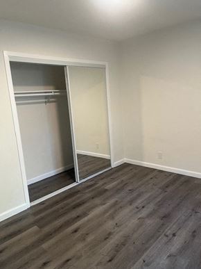 Los Angeles apartment for rent - A room with a sliding door and wood flooring.