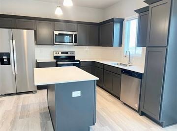 Urbandale house for rent - a kitchen with black cabinets and stainless steel appliances