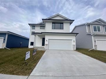 Bondurant house for rent - a white house with a white garage door and a driveway