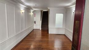San Francisco apartment for rent - a hallway with wood floors and white walls and a staircase