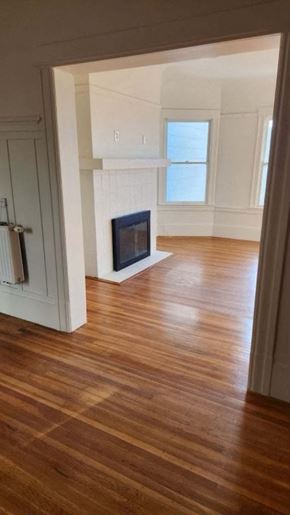San Francisco apartment for rent - a living room with a fireplace and a wooden floor