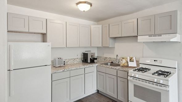 Pontiac apartment for rent - a kitchen with white appliances and white cabinets