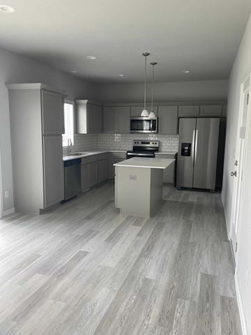 Urbandale house for rent - A modern kitchen with a refrigerator, stove, and cabinets.