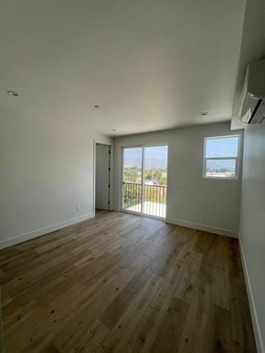 North Hollywood apartment for rent - an empty living room with wooden floors and a balcony